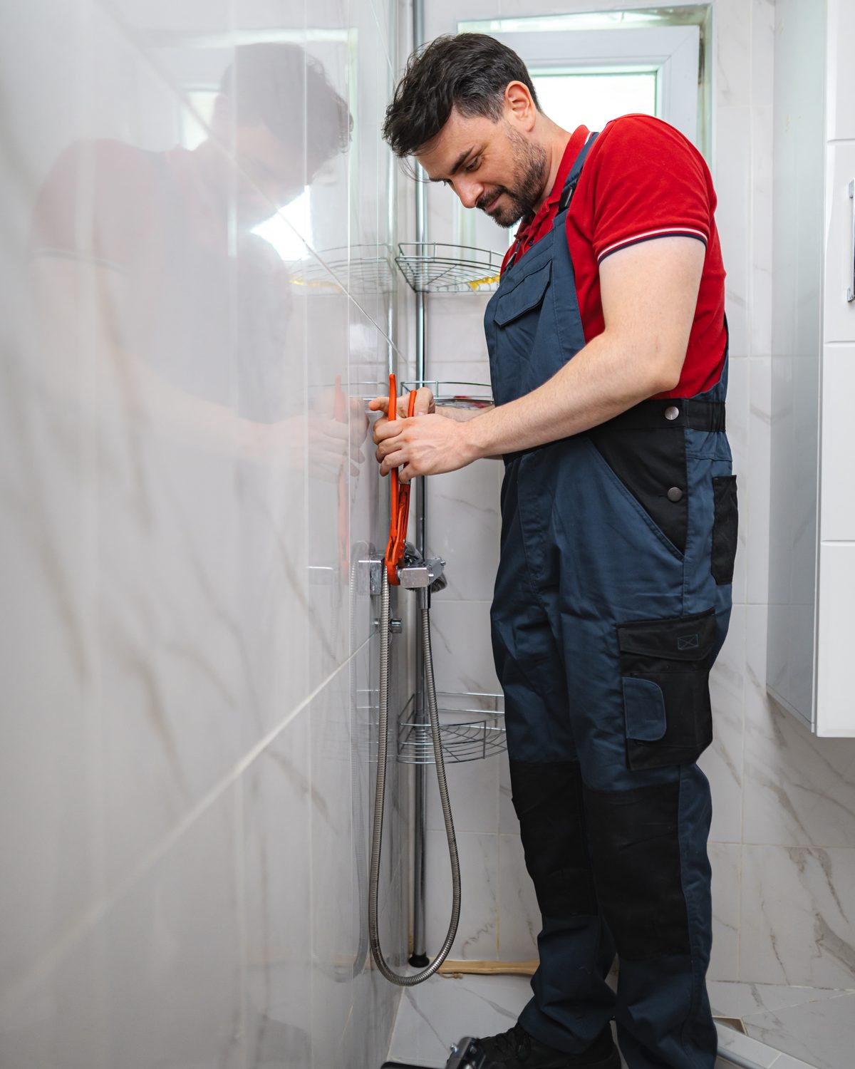 Shower mixer being worked on with a pair of pliers